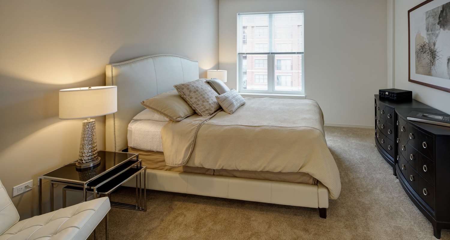 cozy bedroom at Courthouse Square Apartments in Wheaton, IL