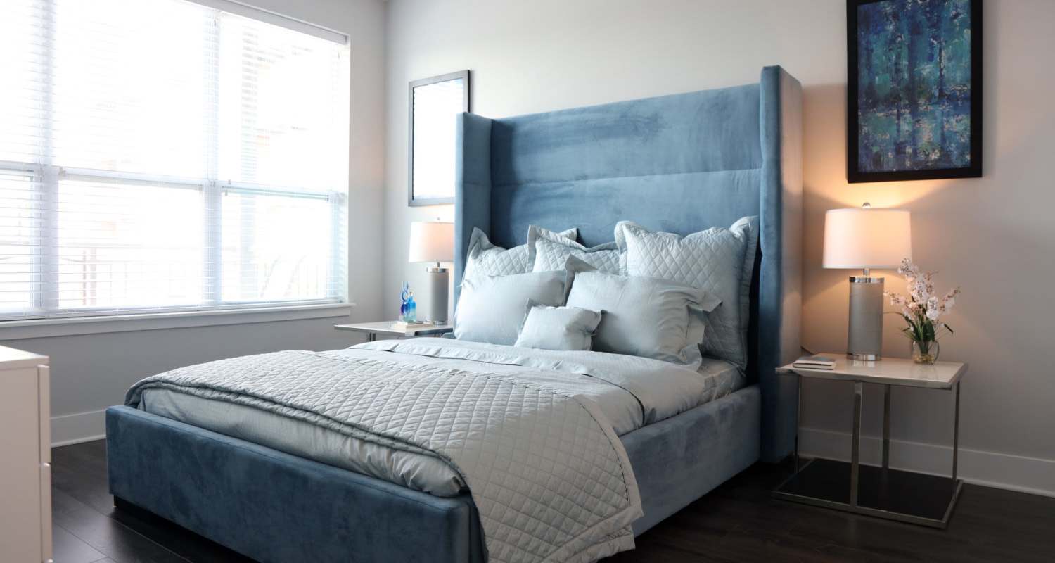 bedroom with blue bedframe at The Residences at Hamilton Lakes in Itasca, IL