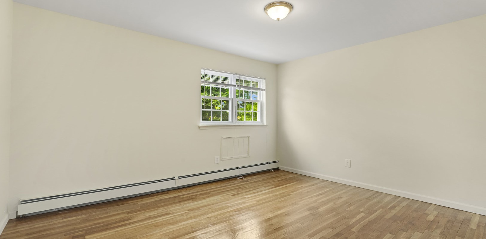 Bedroom with wood style flooring at Balmoral Arms in Matawan, New Jersey