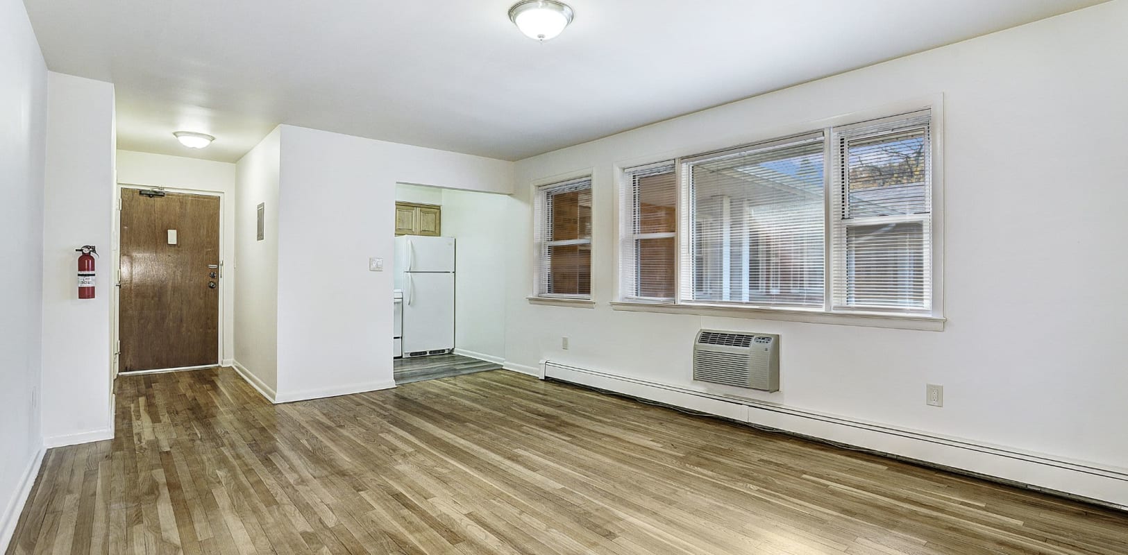 Living room with hardwood flooring at Garret Village Apartments in Clifton, New Jersey