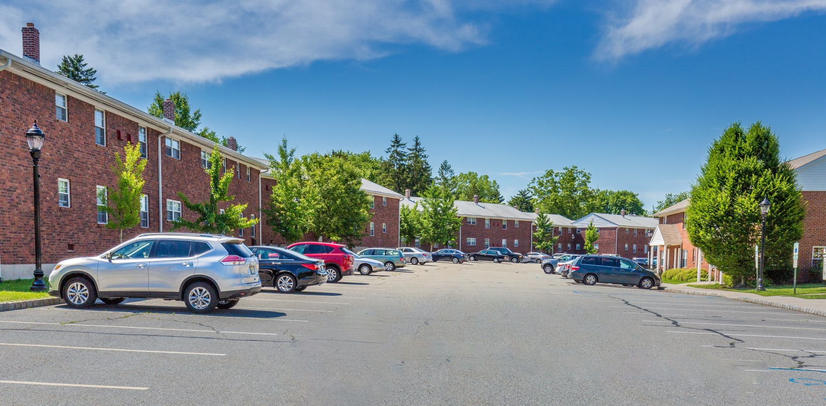 Large parking lot with plenty of space for residents to park at Nottingham Manor in Montvale, New Jersey