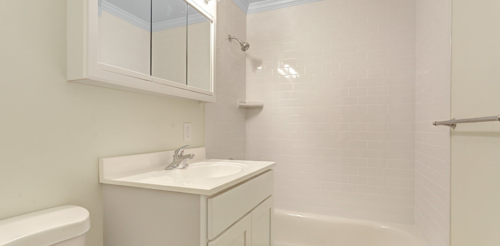 Bathroom with white countertop and vanity mirror at Sharon Arms Apartments in Robbinsville, New Jersey