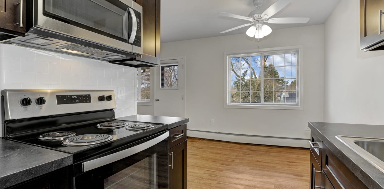 Kitchen with ceiling fan at Versailles Apartments in Ewing, New Jersey