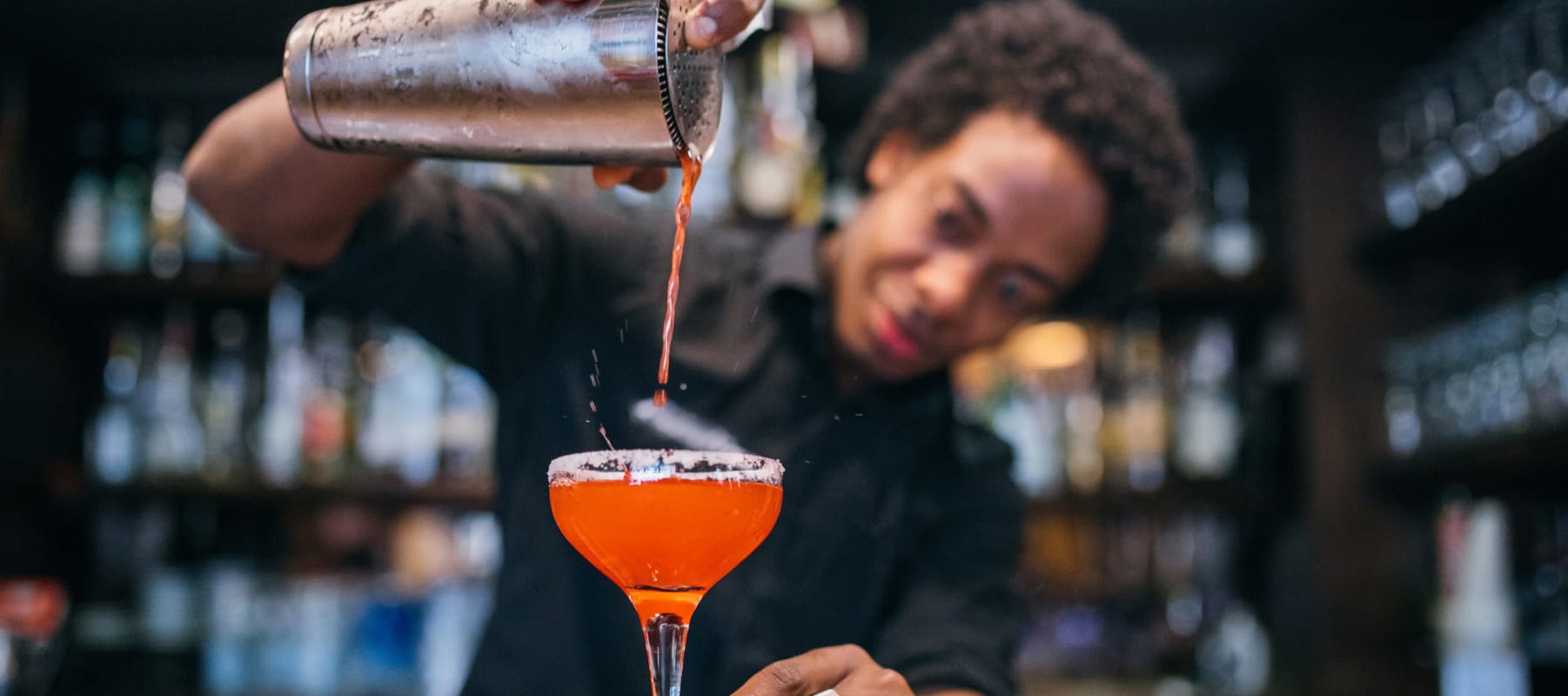 Bartender pouring a mouth-watering cocktail at a bar near 17th Street Lofts in Atlanta, Georgia