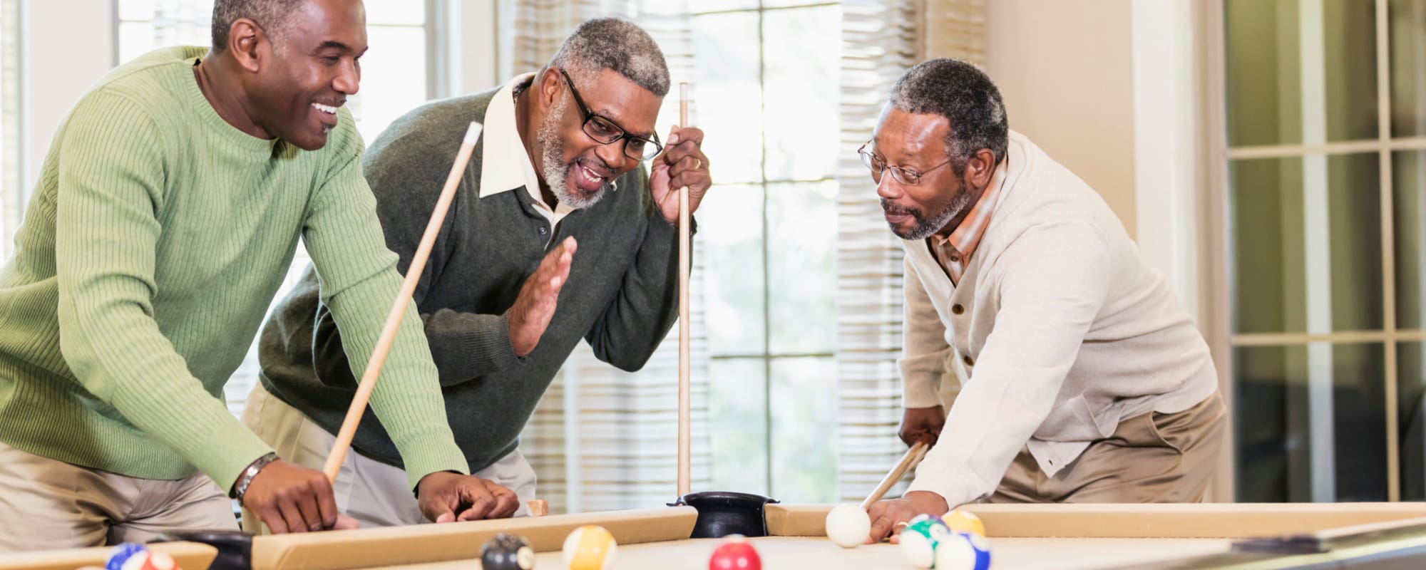 Three men playing pool at Hampton Woods in Columbus, Ohio