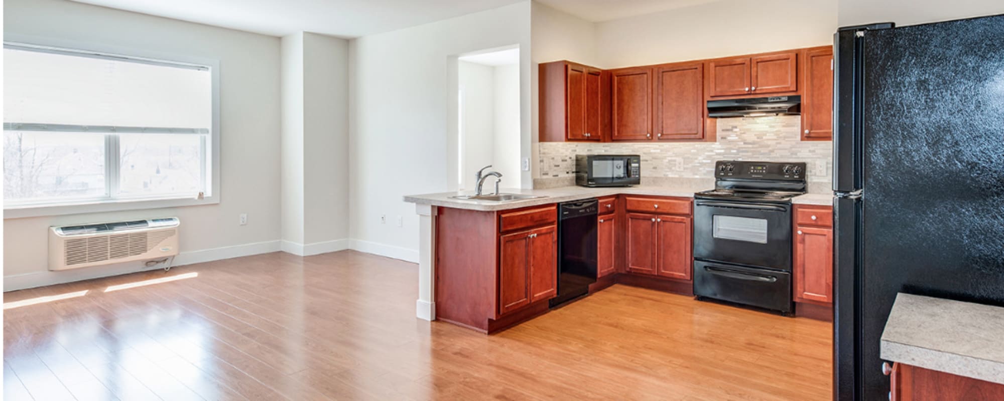 An open apartment kitchen and living room at Grand Meridia Apartments in Rahway, New Jersey