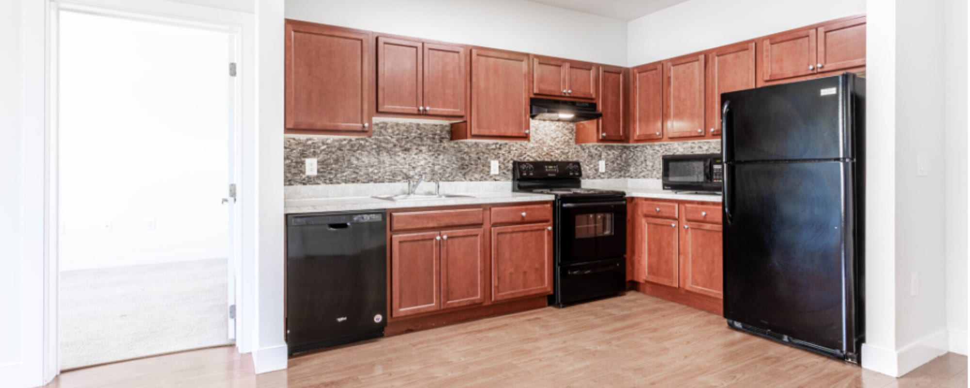 Apartment kitchen with black appliances at Grand Meridia Apartments in Rahway, New Jersey
