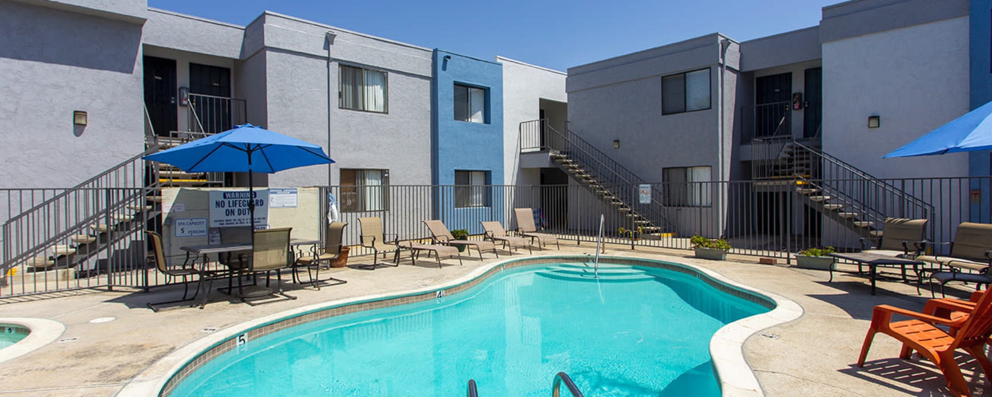Pool with lounge chairs at San Diego, California, apartments at Bridgeview Apartments