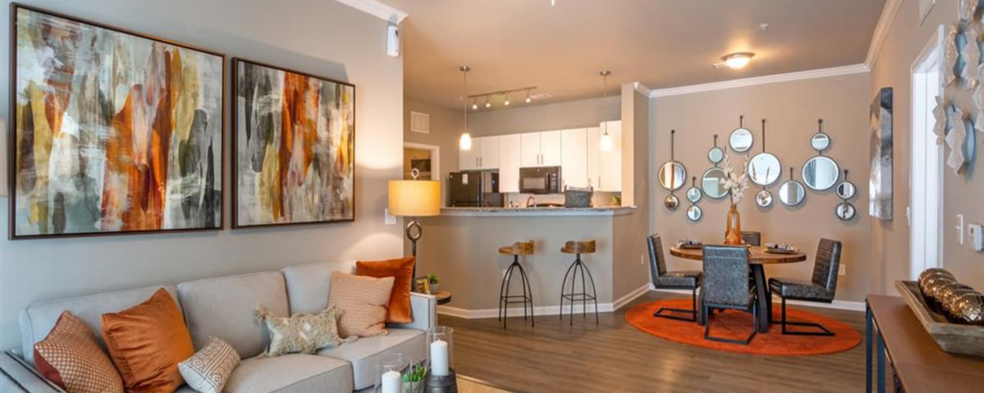 A furnished apartment living room and kitchen at Lullwater at Blair Stone in Tallahassee, Florida