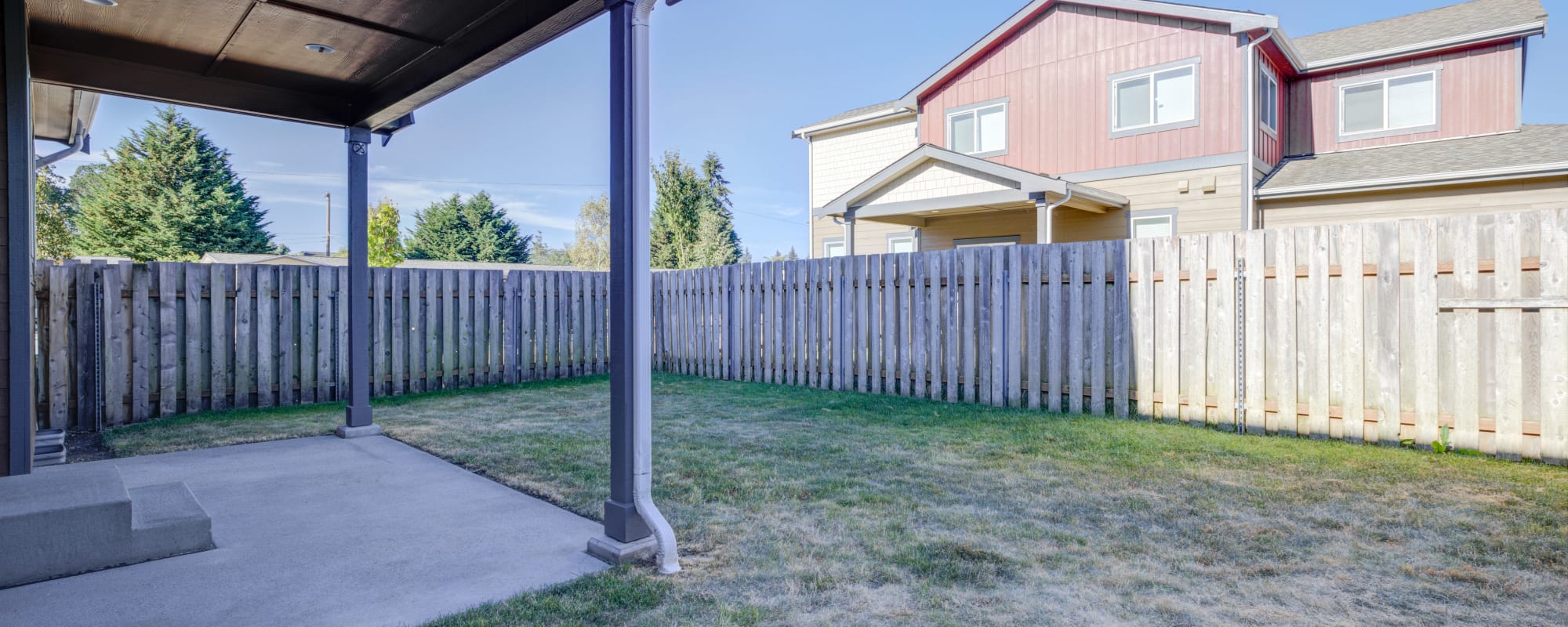 Fenced backyard with covered patio at Stony Oak in Joint Base Lewis McChord, Washington