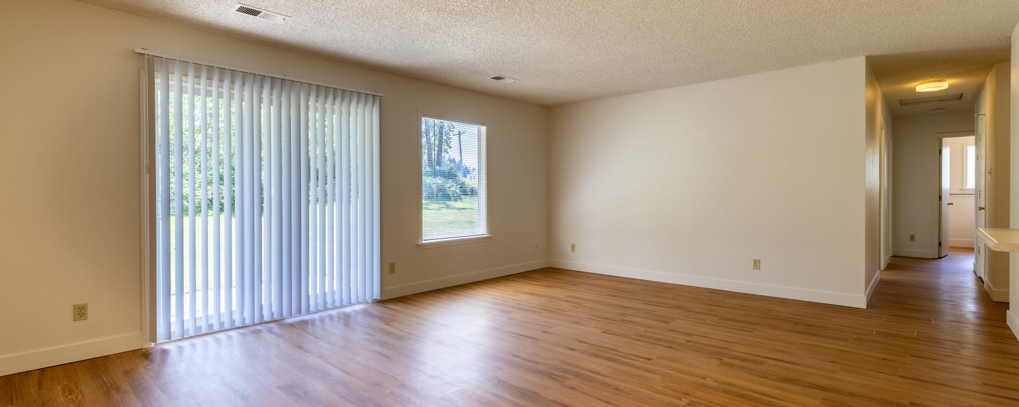 Open concept living room with access to backyard at New Hillside in Joint Base Lewis McChord, Washington