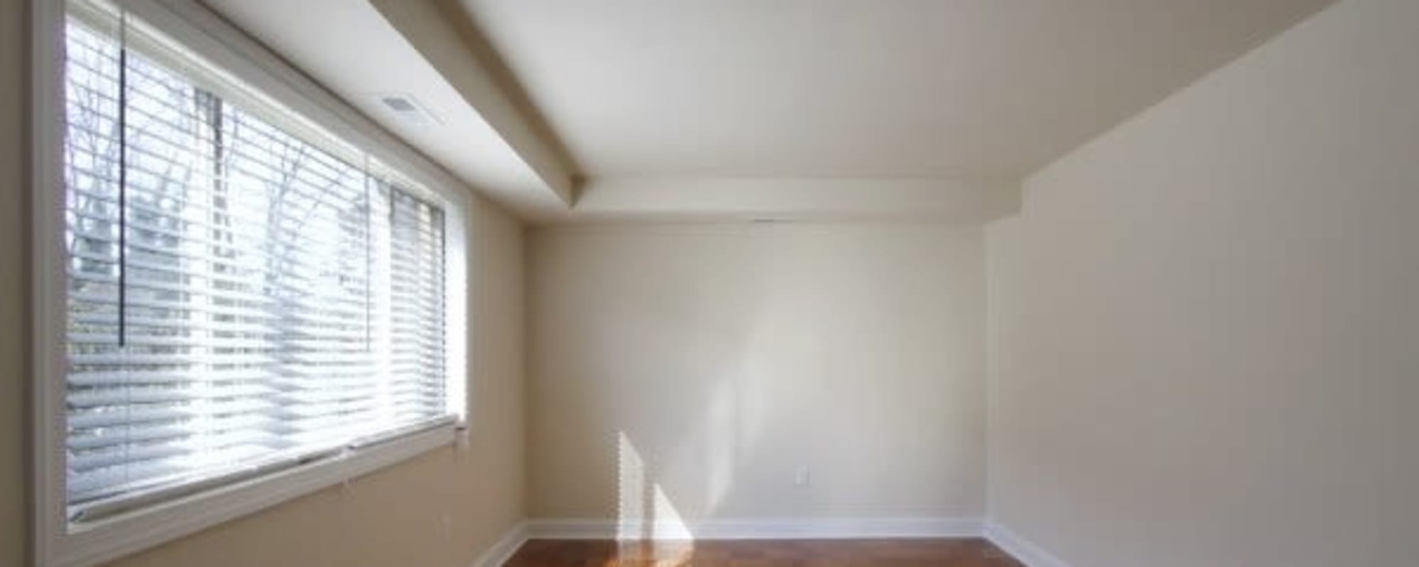 Empty apartment bedroom with a large window at Chelsea Park in Gaithersburg, Maryland