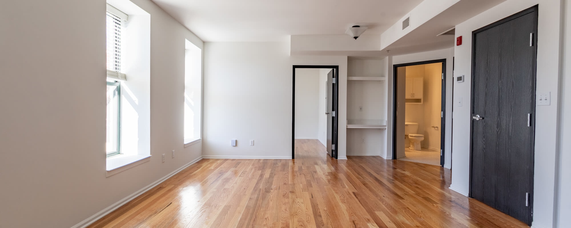 Living room with doors to the bedroom and bathroom at Rink Savoy in Indianapolis, Indiana