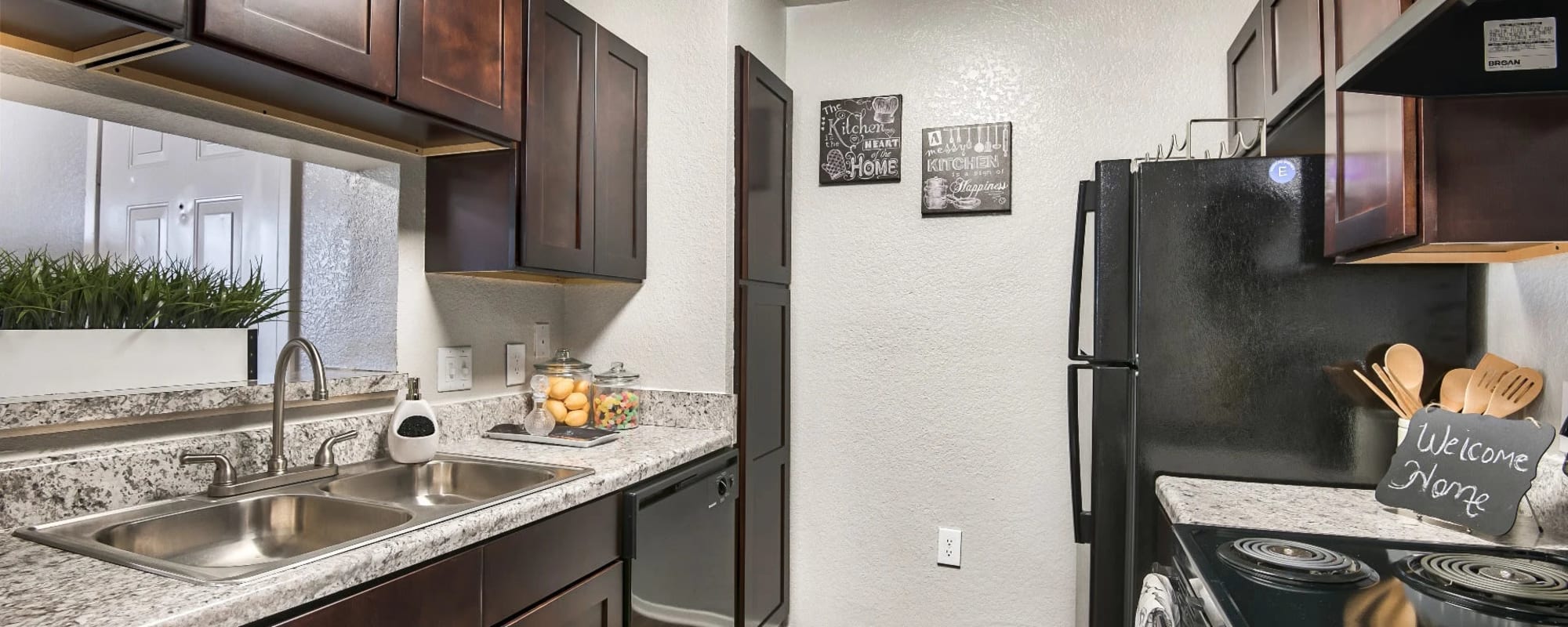 Granite countertops and black appliances in a model apartment at Reserve at Stillwater in Durham, North Carolina