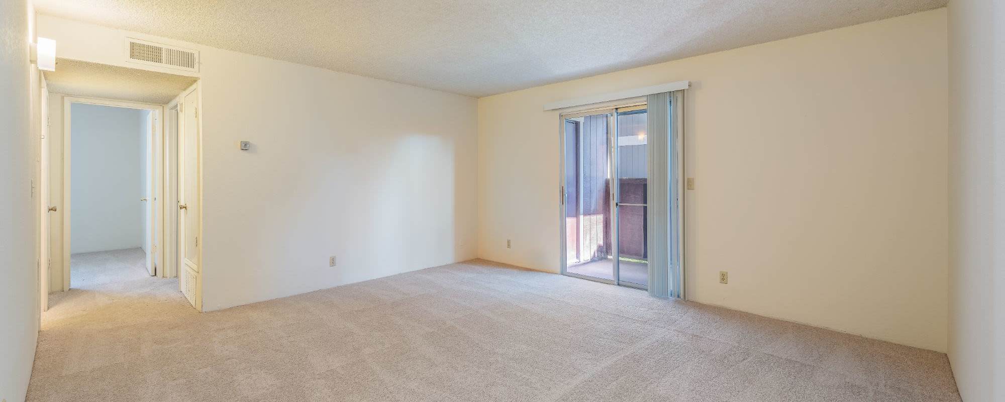 Model living room with soft carpet at Rosewood Park Apartments in Reno, Nevada