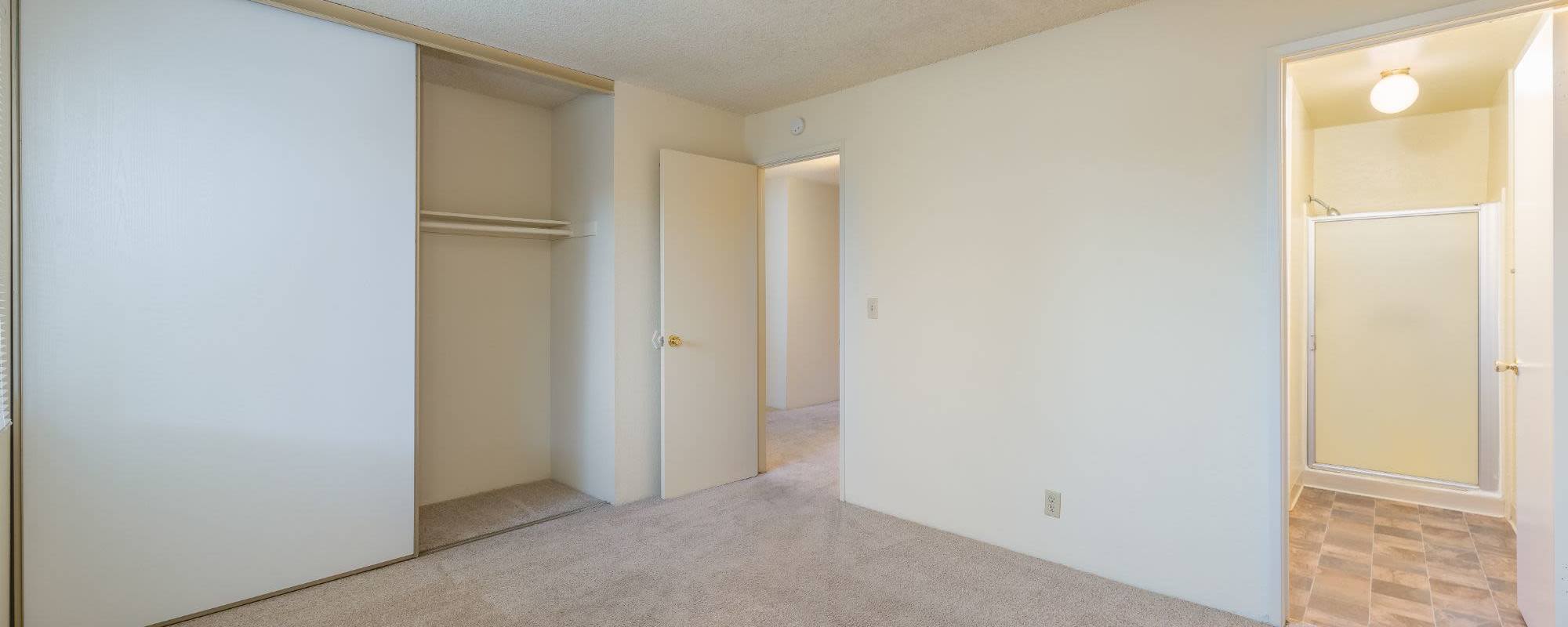 Model bedroom space with bathroom at Rosewood Park Apartments in Reno, Nevada