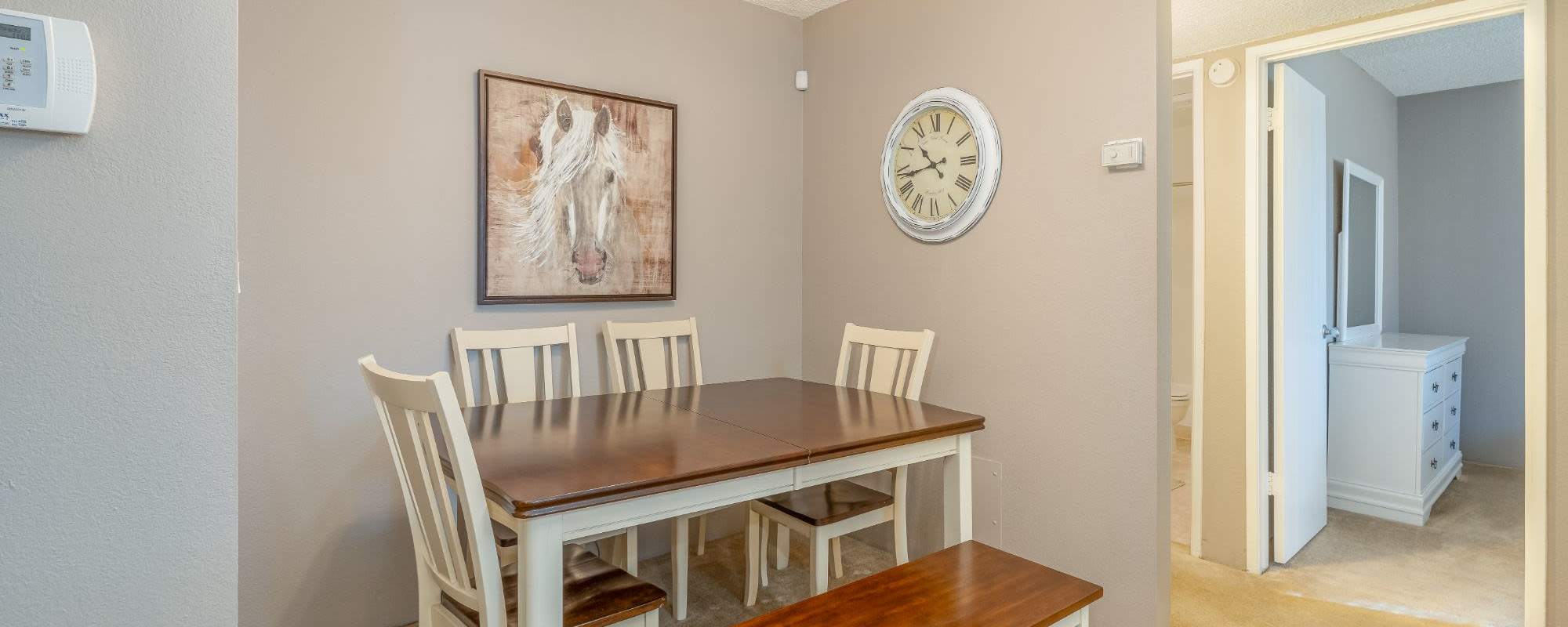 Dining table with wall art at Rosewood Park Apartments in Reno, Nevada