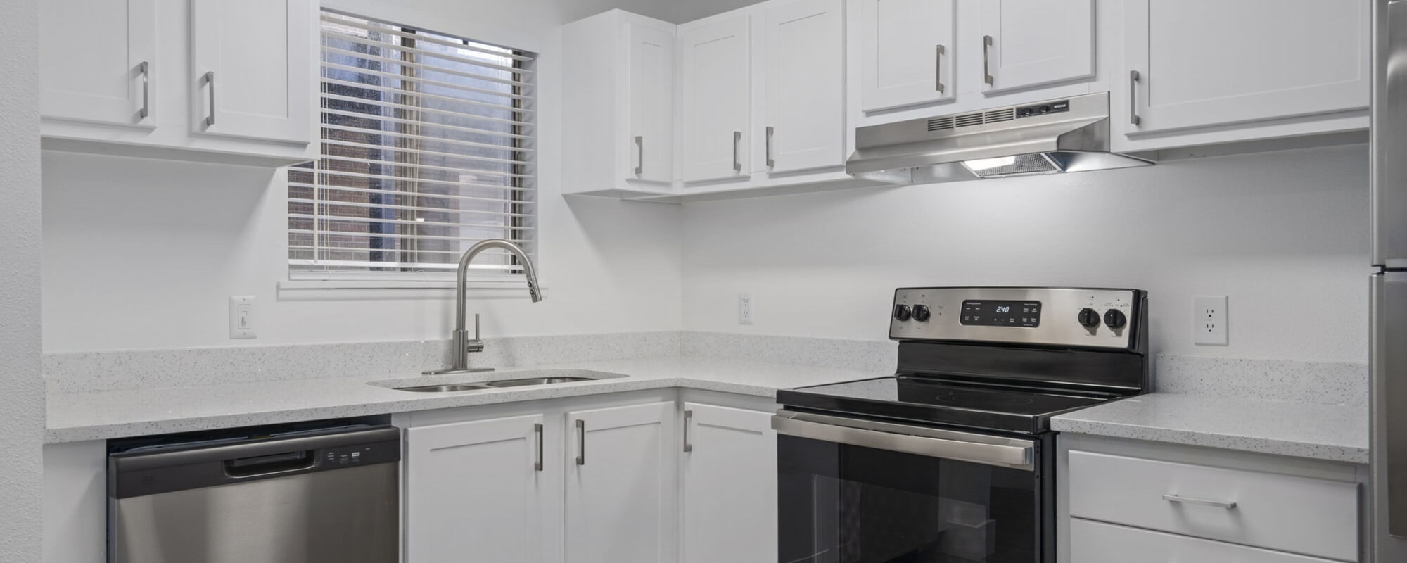 Model kitchen with white accents at The Franklyn Apartments in Millcreek, Utah