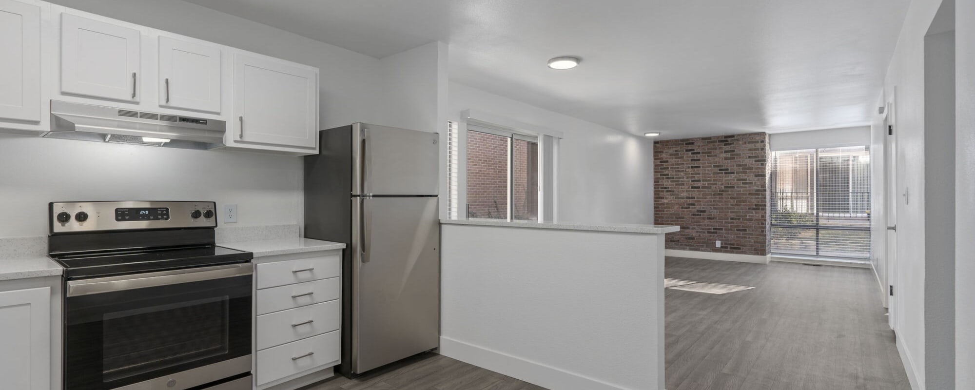 Model kitchen leading to living space at The Franklyn Apartments in Millcreek, Utah