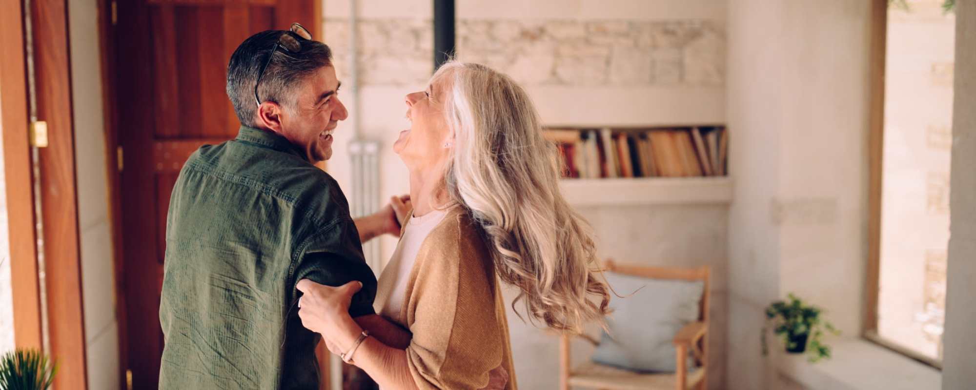 Resident couple dancing in their apartment at The Adrian in Marietta, Georgia