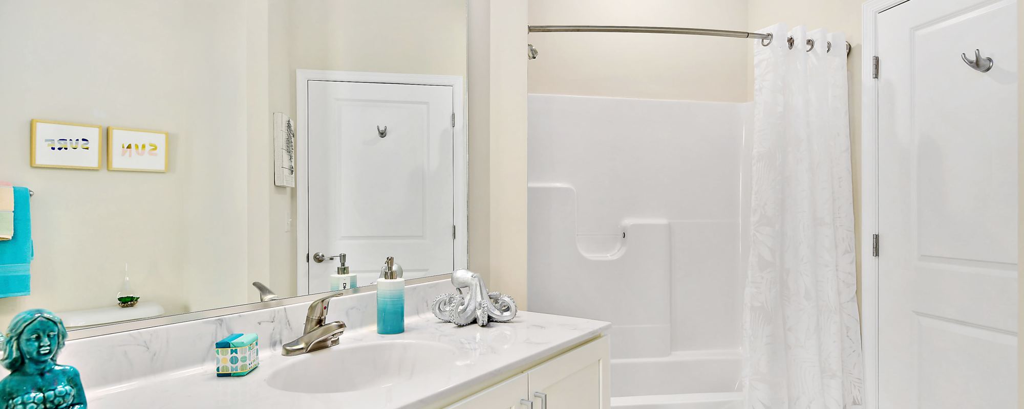 Bathroom with large mirrors at Oceans East in Berlin, Maryland