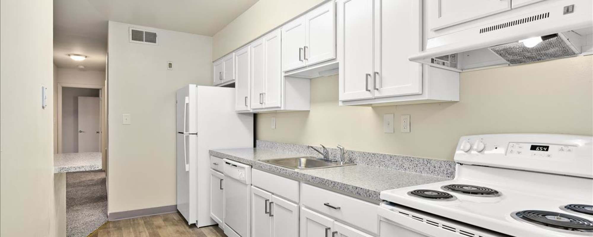 Kitchen with white appliances at Parkwood Apartments in Salisbury, Maryland