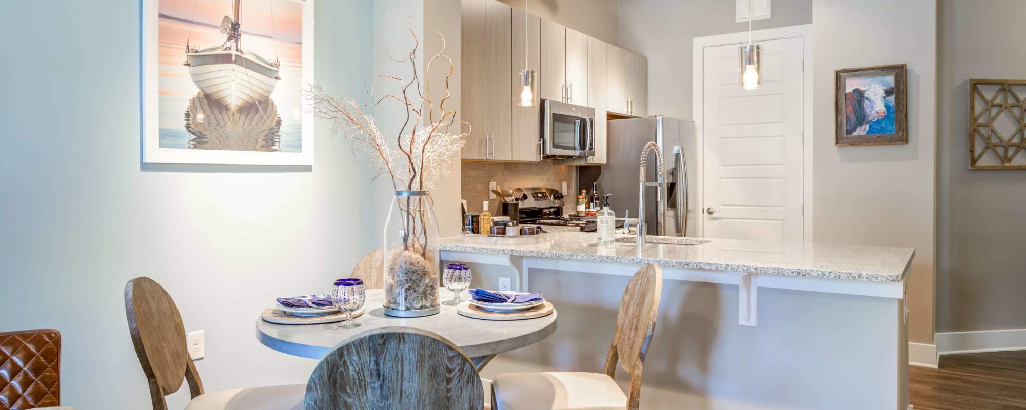 Kitchen and dinning space with wood-style flooring at The Heyward in Charleston, South Carolina