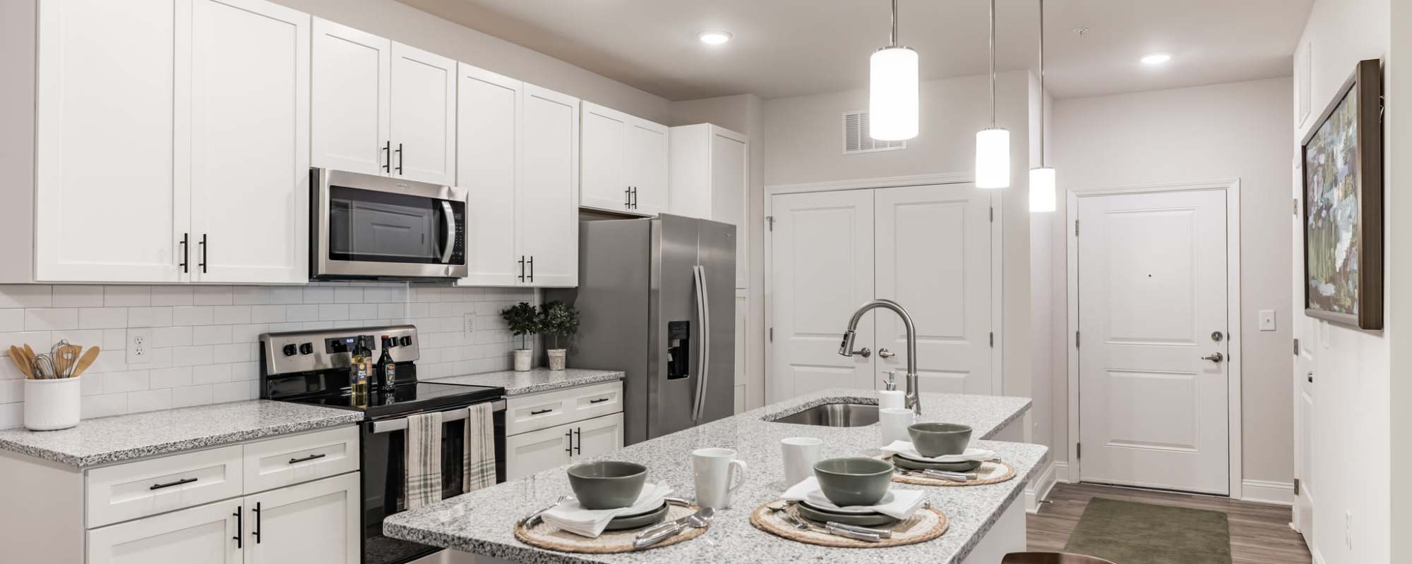 Kitchen and island in a model home at The Standard at Pinestone in Travelers Rest, South Carolina