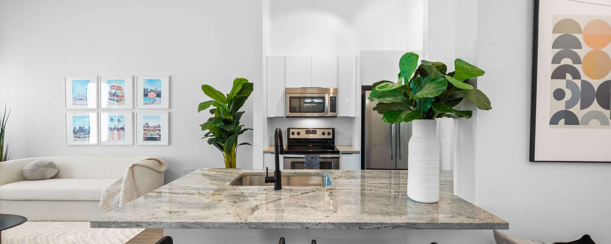 Open concept kitchen and living room in an apartment at Cordoba in Doral, Florida