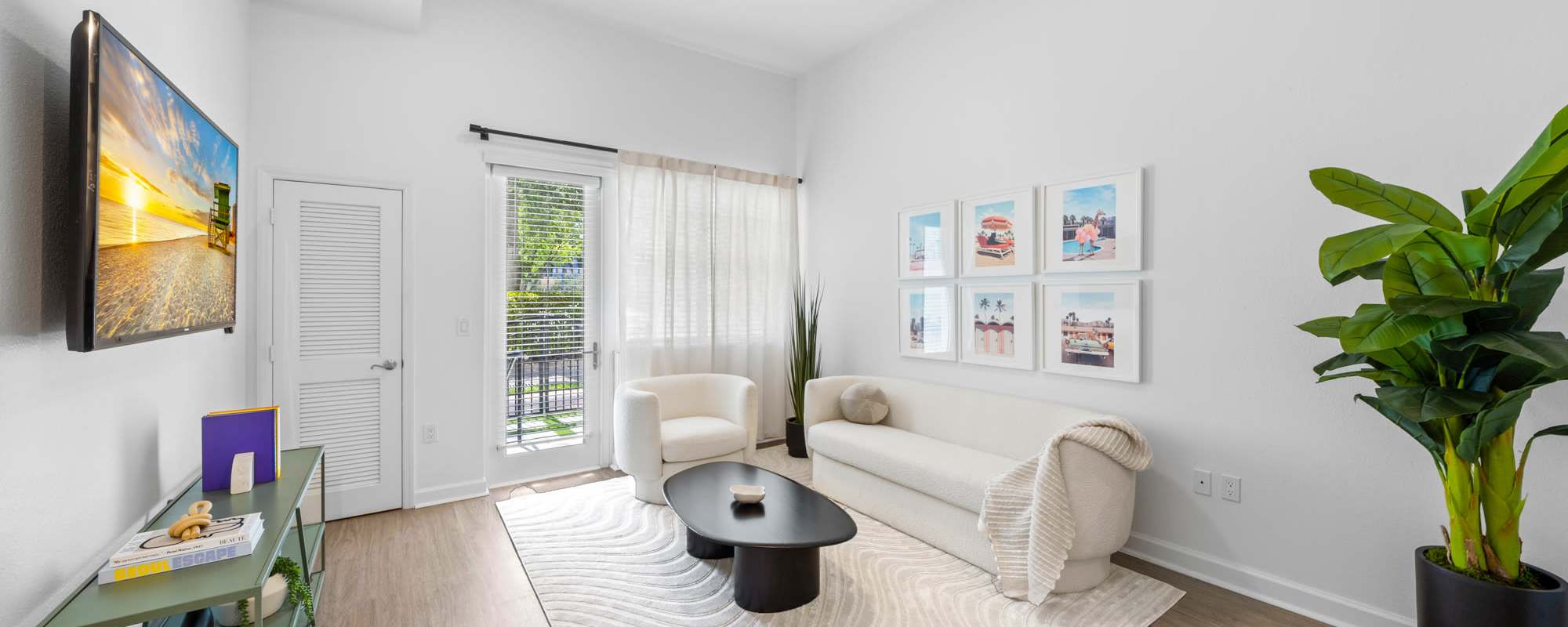 Living room with a door out to a private patio at Cordoba in Doral, Florida