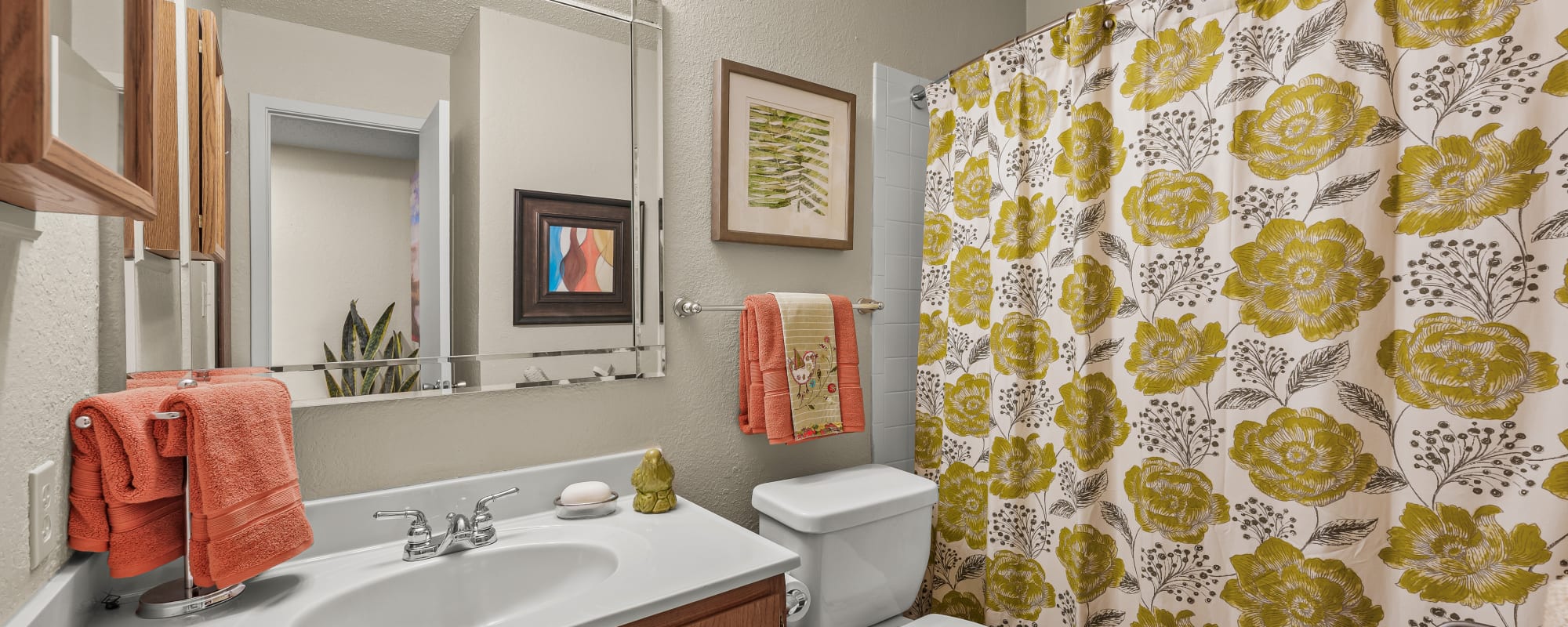 well-lit bathroom with bathtub and vanity at Millicent Crossing in Shreveport, Louisiana