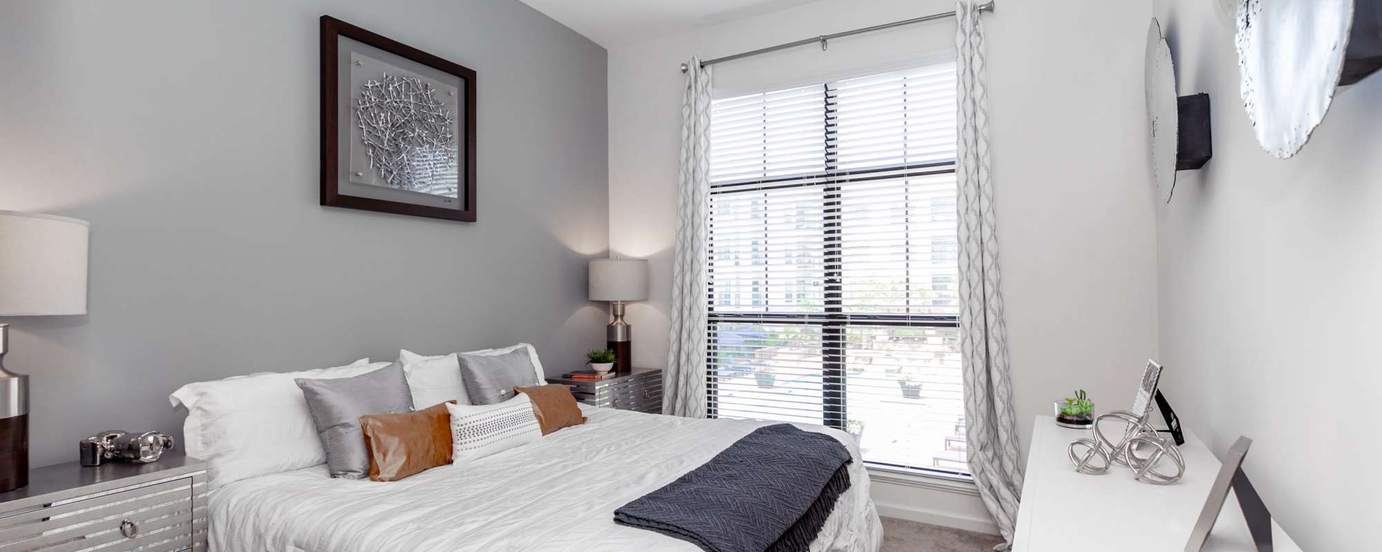 Cozy bedroom with ample lighting at Brookleigh Flats in Brookhaven, Georgia