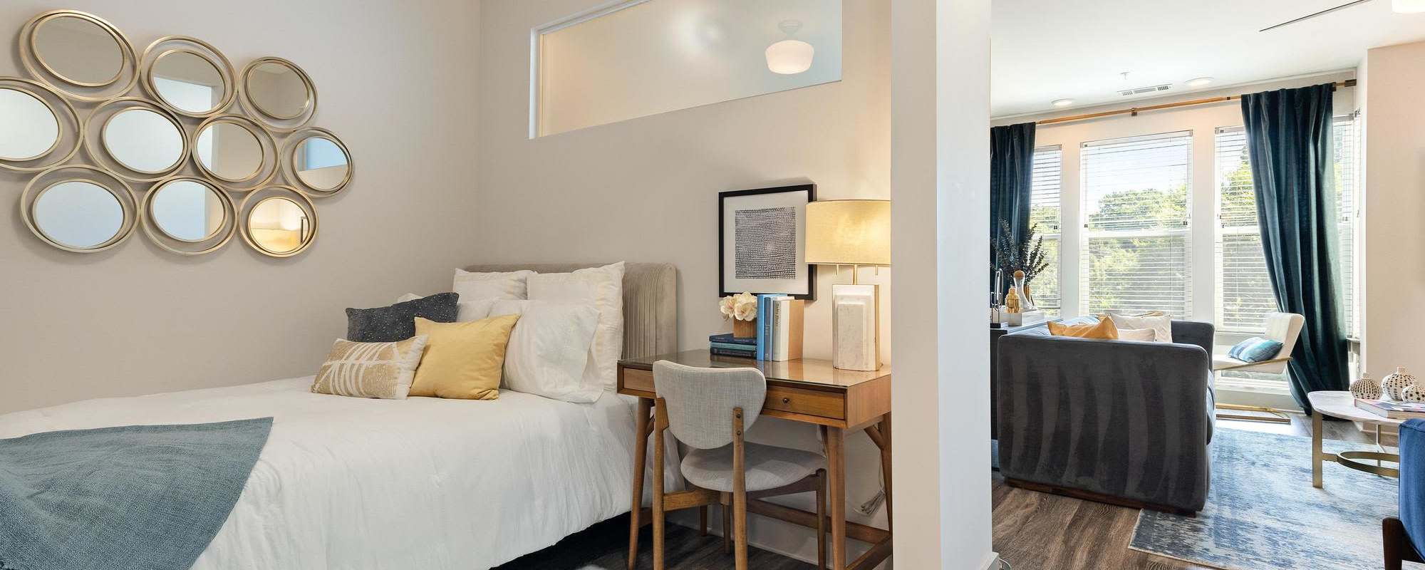 Bedroom with small bed and desk at The Dartmouth North Hills in Raleigh, North Carolina