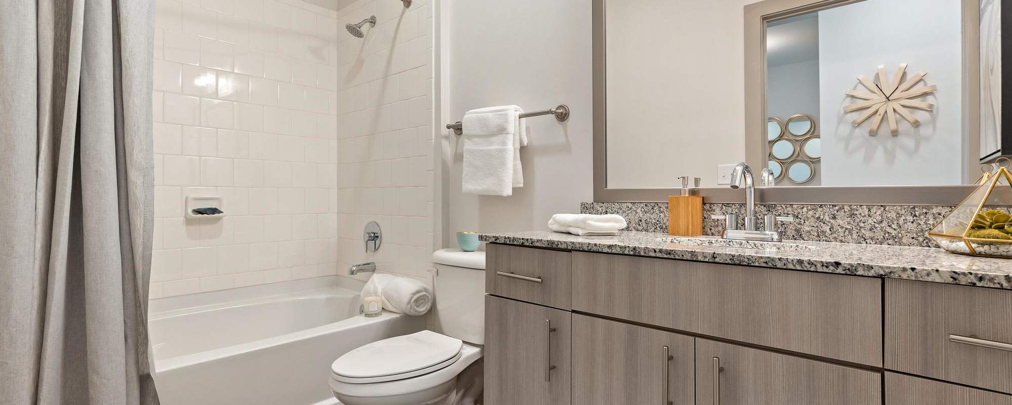 Full bathroom with large mirror at The Dartmouth North Hills in Raleigh, North Carolina
