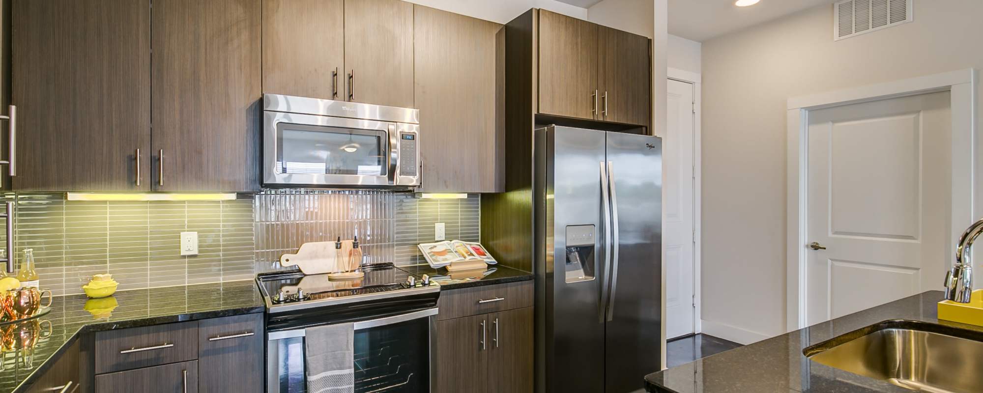 Premium looking kitchen with dark cabinetry and appliances at Factory Design District in Dallas,Texas