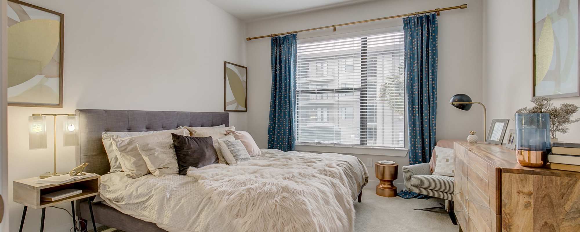 Spacious bedroom with large bed and a large window at Factory Design District in Dallas,Texas