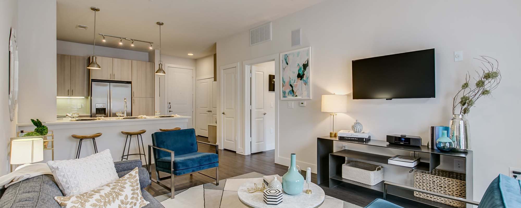 Bright living room with a wall-mount TV and premium furniture at Factory Design District in Dallas,Texas