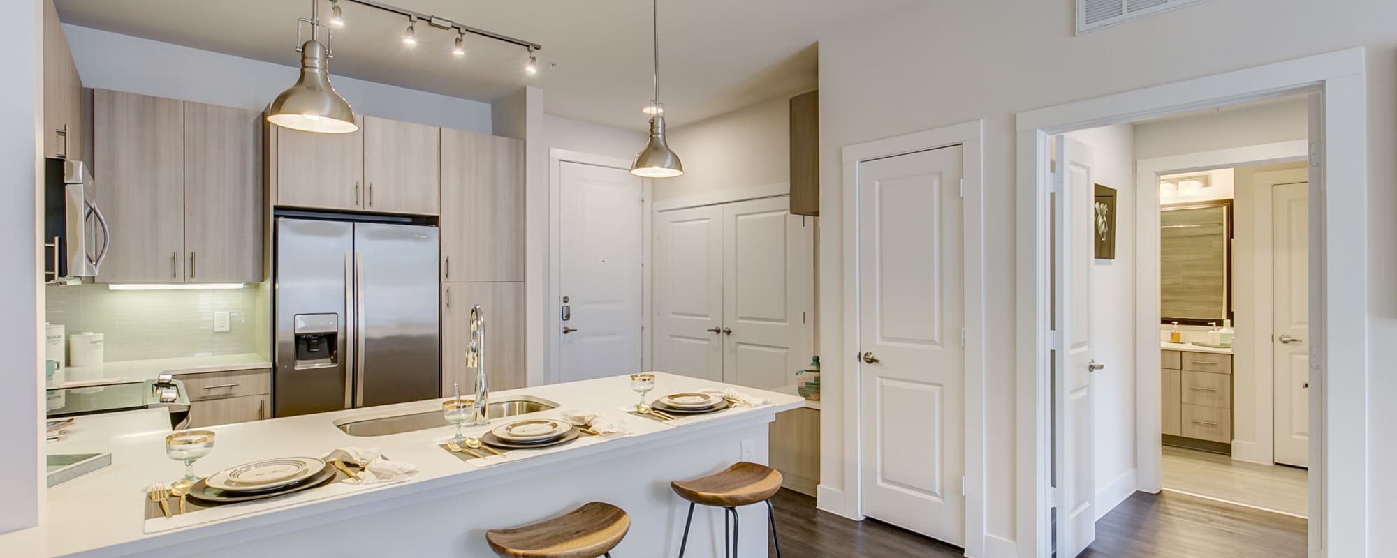 Island kitchen with white granite countertop and bar stools at Factory Design District in Dallas,Texas