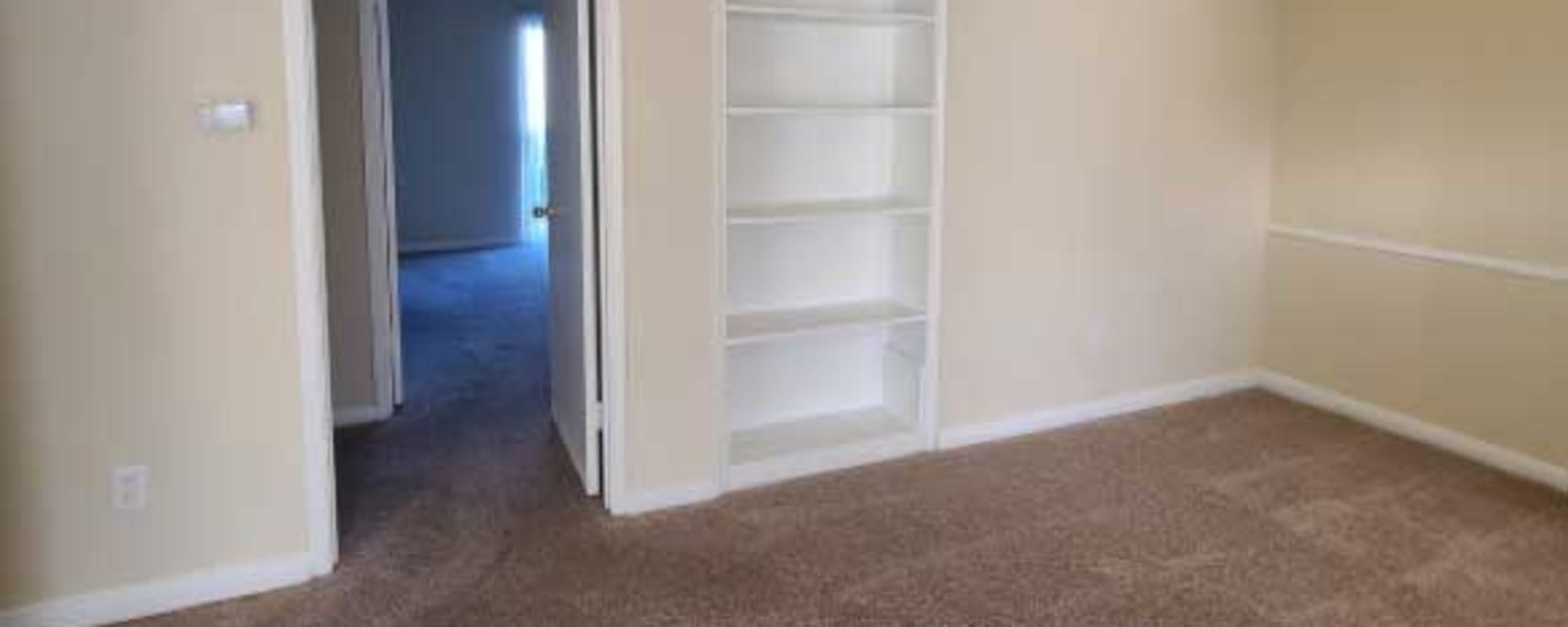 Living room with built-in shelving at Morgan Manor in Houston, Texas