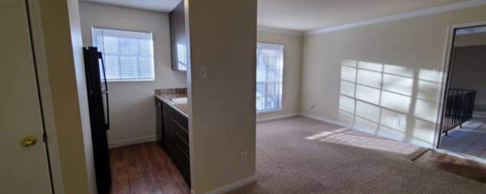 Kitchen near the carpeted living room at Morgan Manor in Houston, Texas