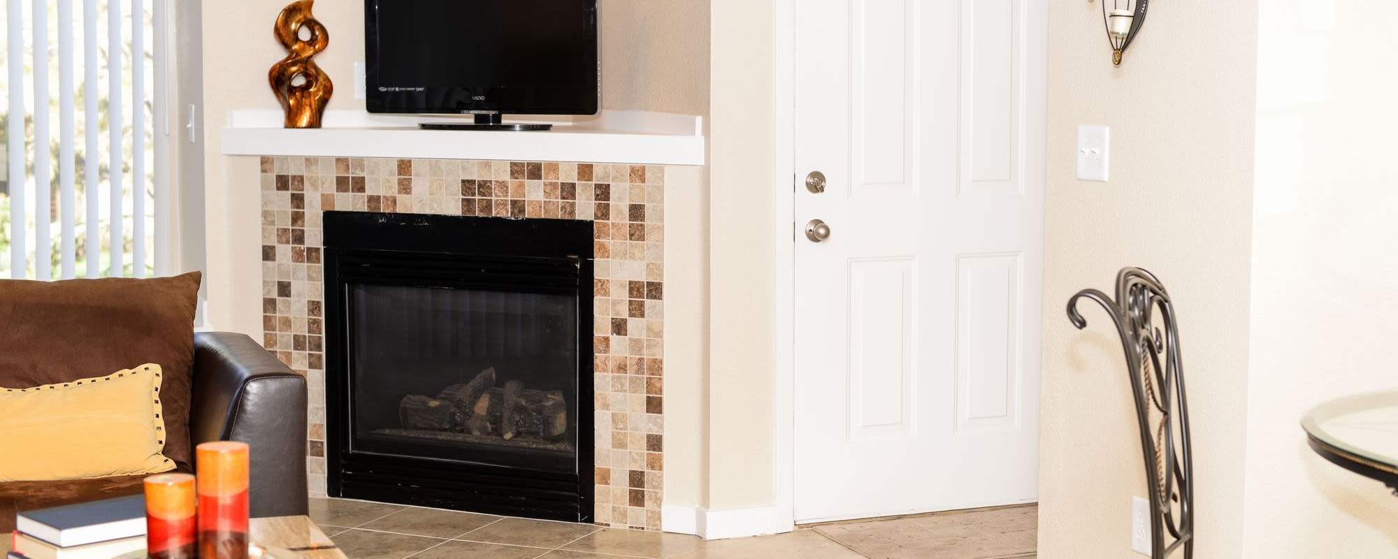 Living room with fireplace at UTE Creek Apartments in Longmont, Colorado, 