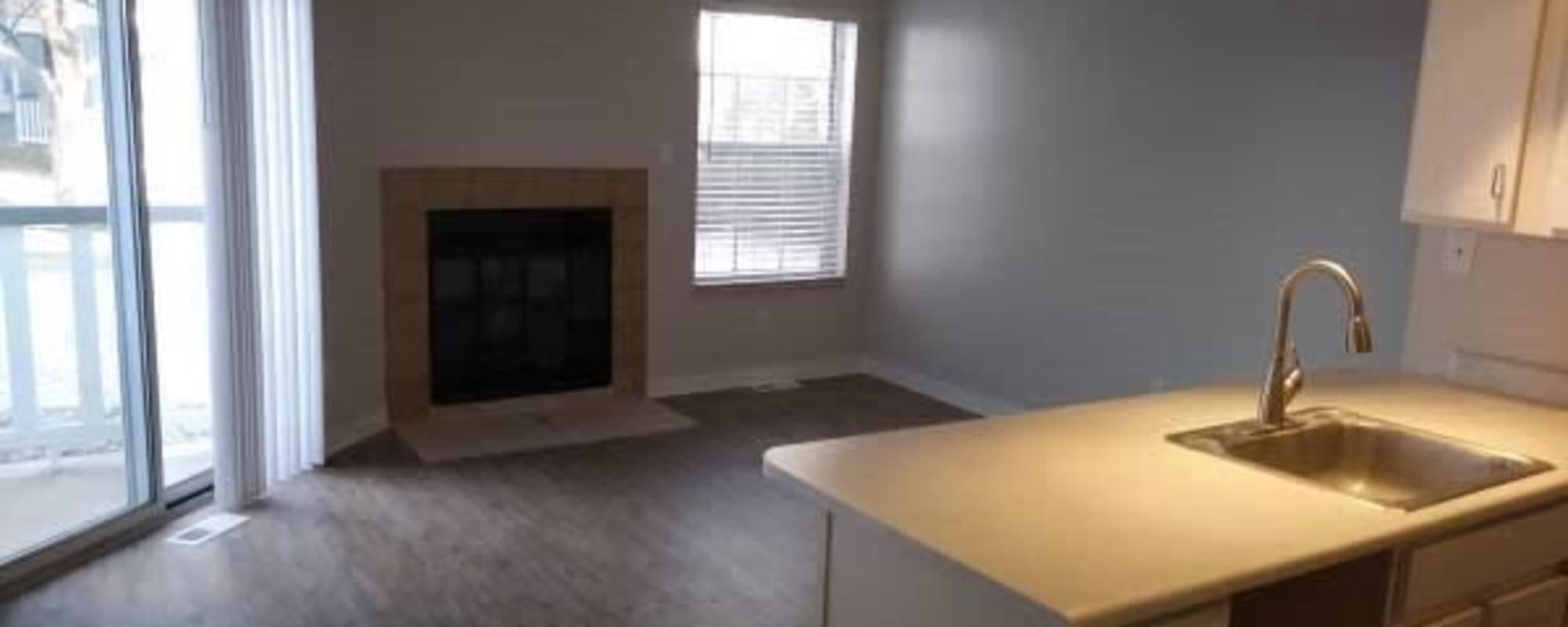 Apartment living room with fireplace at Victoria Inn Apartments in Longmont, Colorado