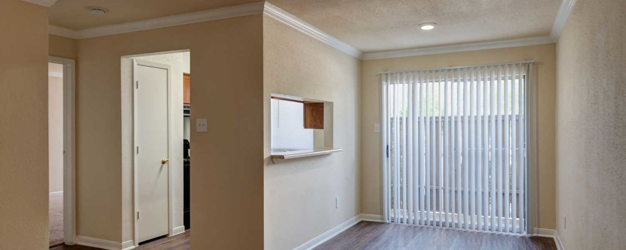 Living room with hardwood floors and blinds at Sharpstown Park in Houston, Texas