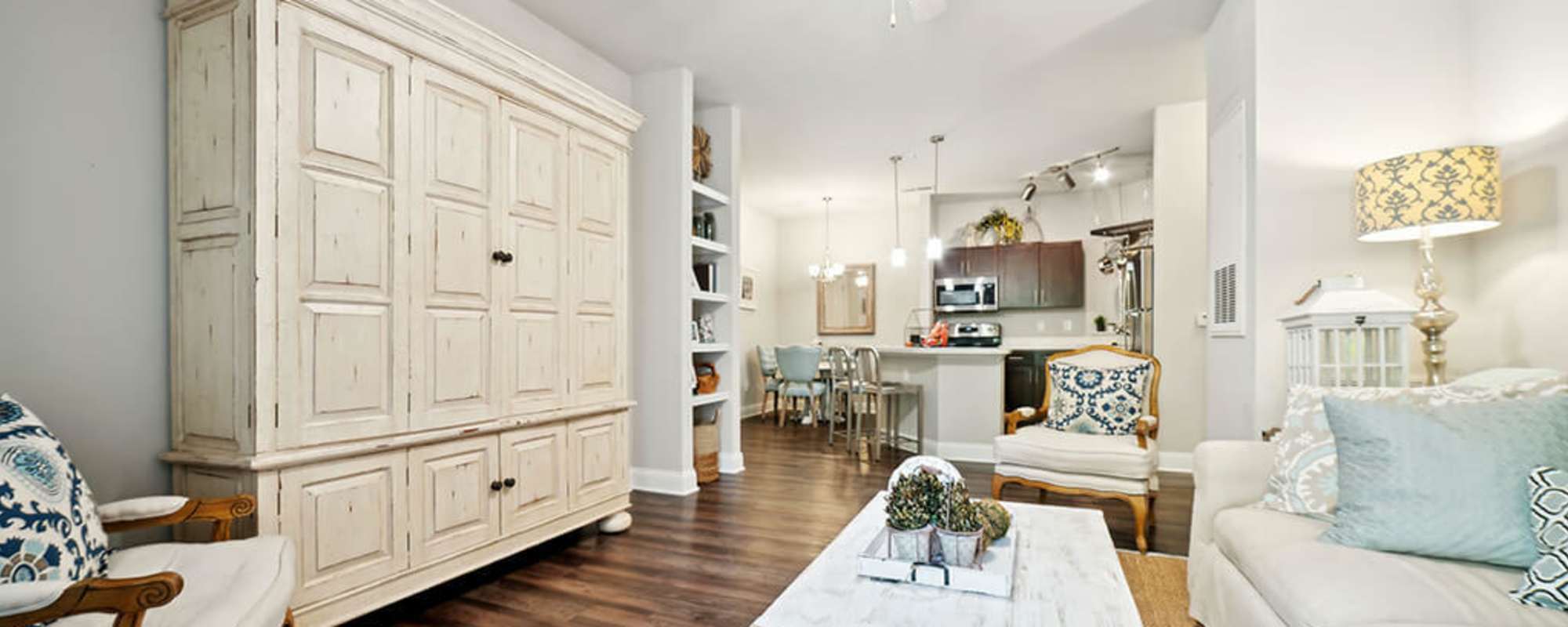 Living room with wood flooring at The Apartments at Shade Tree in Johns Island, South Carolina