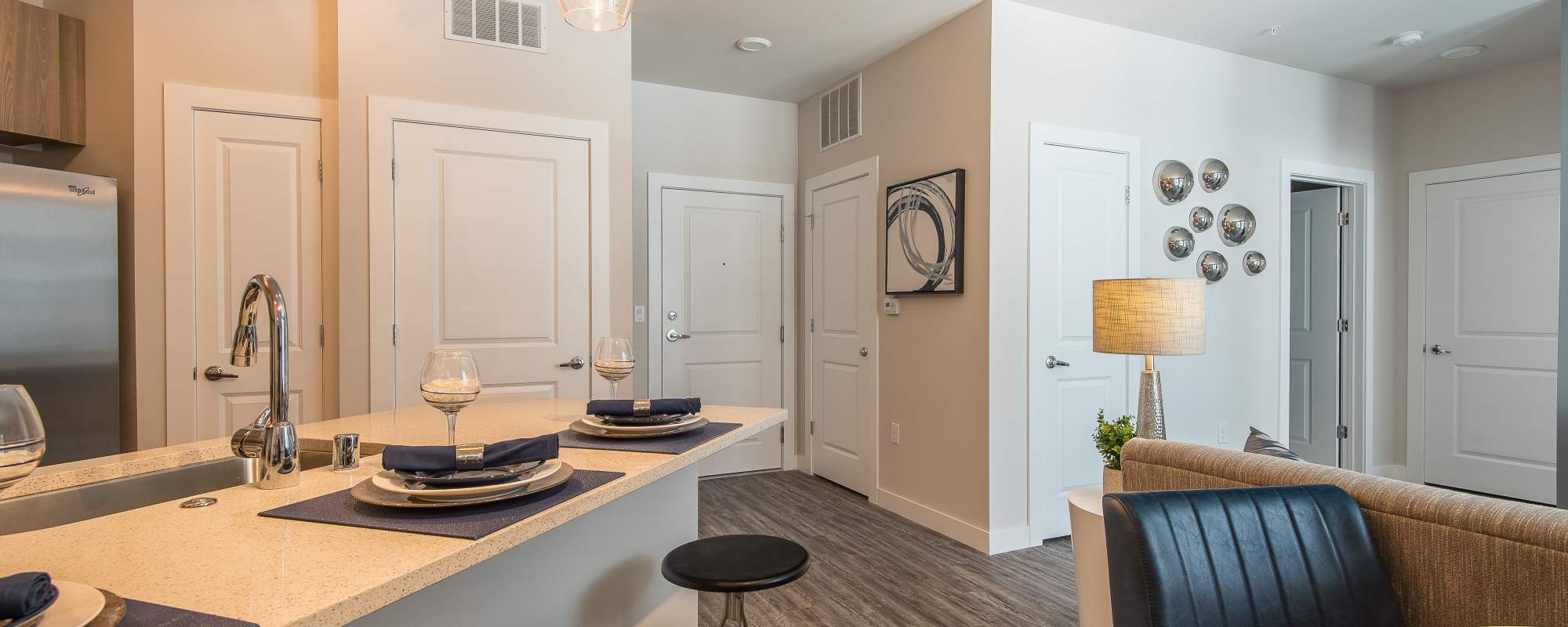 View of a room with multiple doors and kitchen bar at Mayfair Reserve in Wauwatosa, Wisconsin