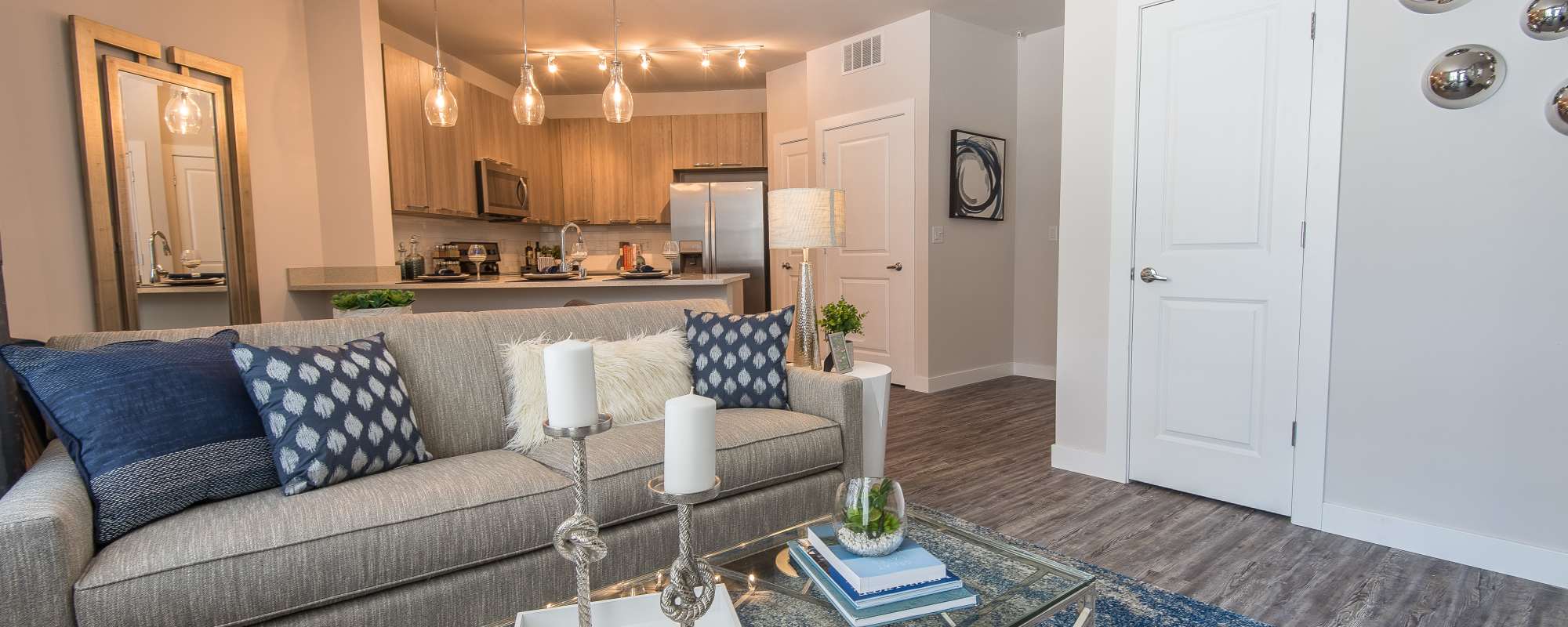 A living room space with furniture candles and books at Mayfair Reserve in Wauwatosa, Wisconsin