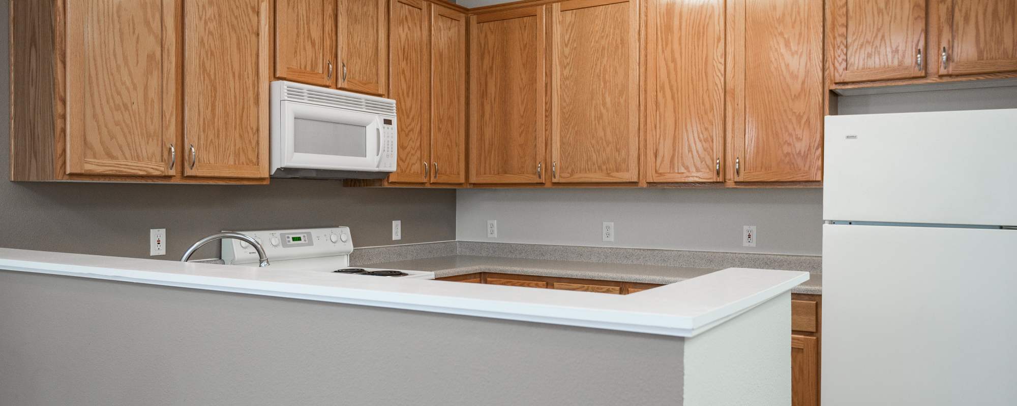 Kitchen with breakfast counter top at Chinook Way Apartments in Fairview, Oregon