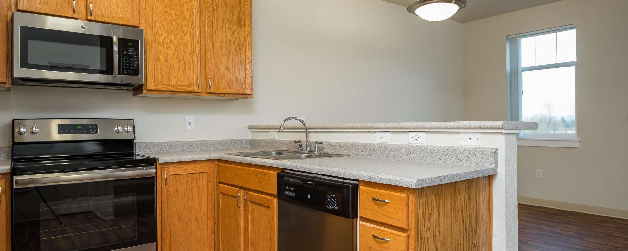 Kitchen with stainless steel appliance at Chinook Way Apartments in Fairview, Oregon