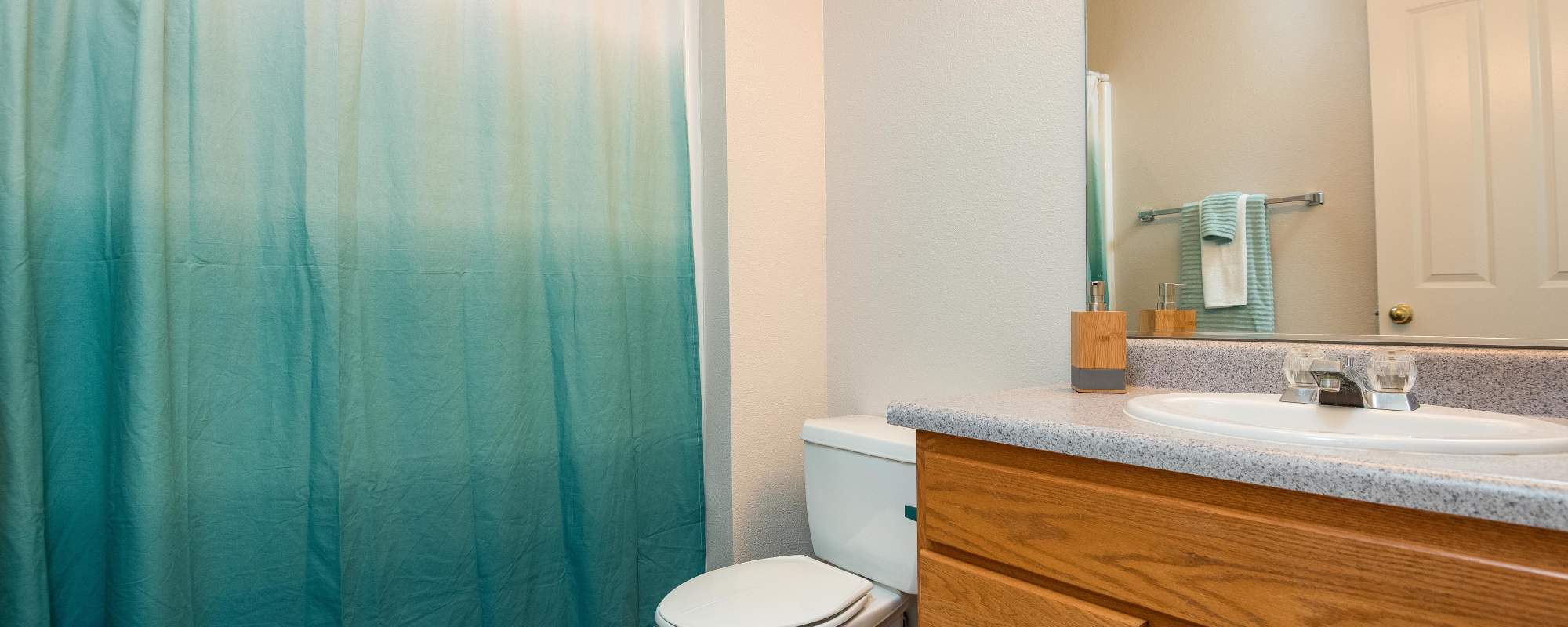 Bathroom with vanity mirror at Chinook Way Apartments in Fairview, Oregon