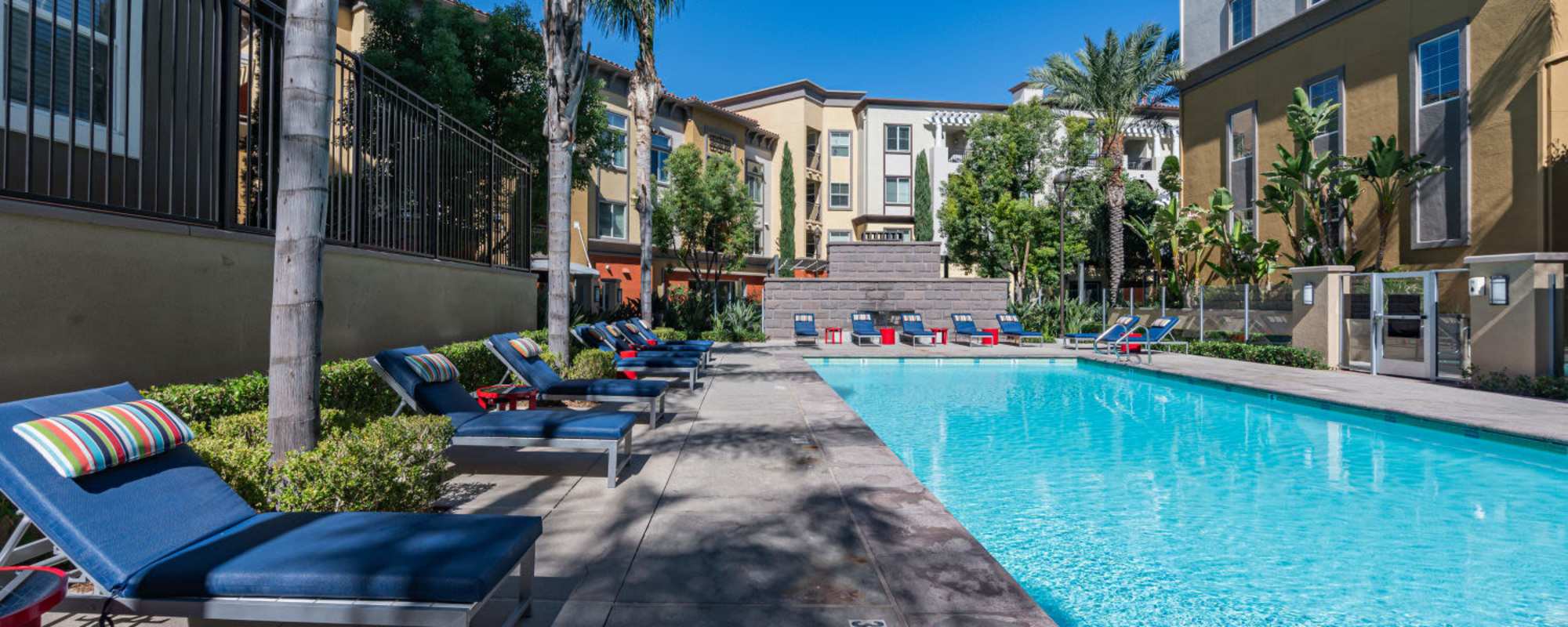 Swimming pool with lounge chair at The Boulevard Apartment Homes in Woodland Hills, California